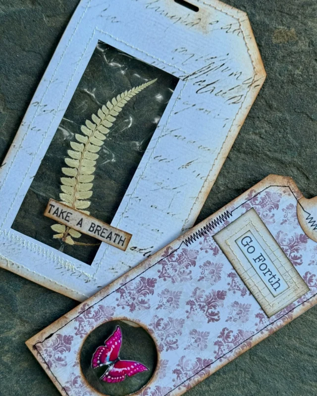 These nature-inspired tags feature a clear laminated pocket that lets you showcase anything flat and beautiful—pressed flowers, feathers, die cuts, vintage ephemera, and more.
Each one becomes its own little framed story, stitched together with love and a dash of imagination.

Use them as journal inserts, gift tags, bookmarks, or tiny windows of calm.
What would you tuck inside? 🌿🦋🌸

#hitherandyonstudio #junkjournaltags #pressedflowers #laminatedtags #botanicalephemera #junkjournalinserts #vintagestylecrafts #handmadeephemera #stationerylove #transparentjournaling #junkjournalideas #vintagebotanicals #natureinspiredcrafts #tagjunkies #clearwindowtags